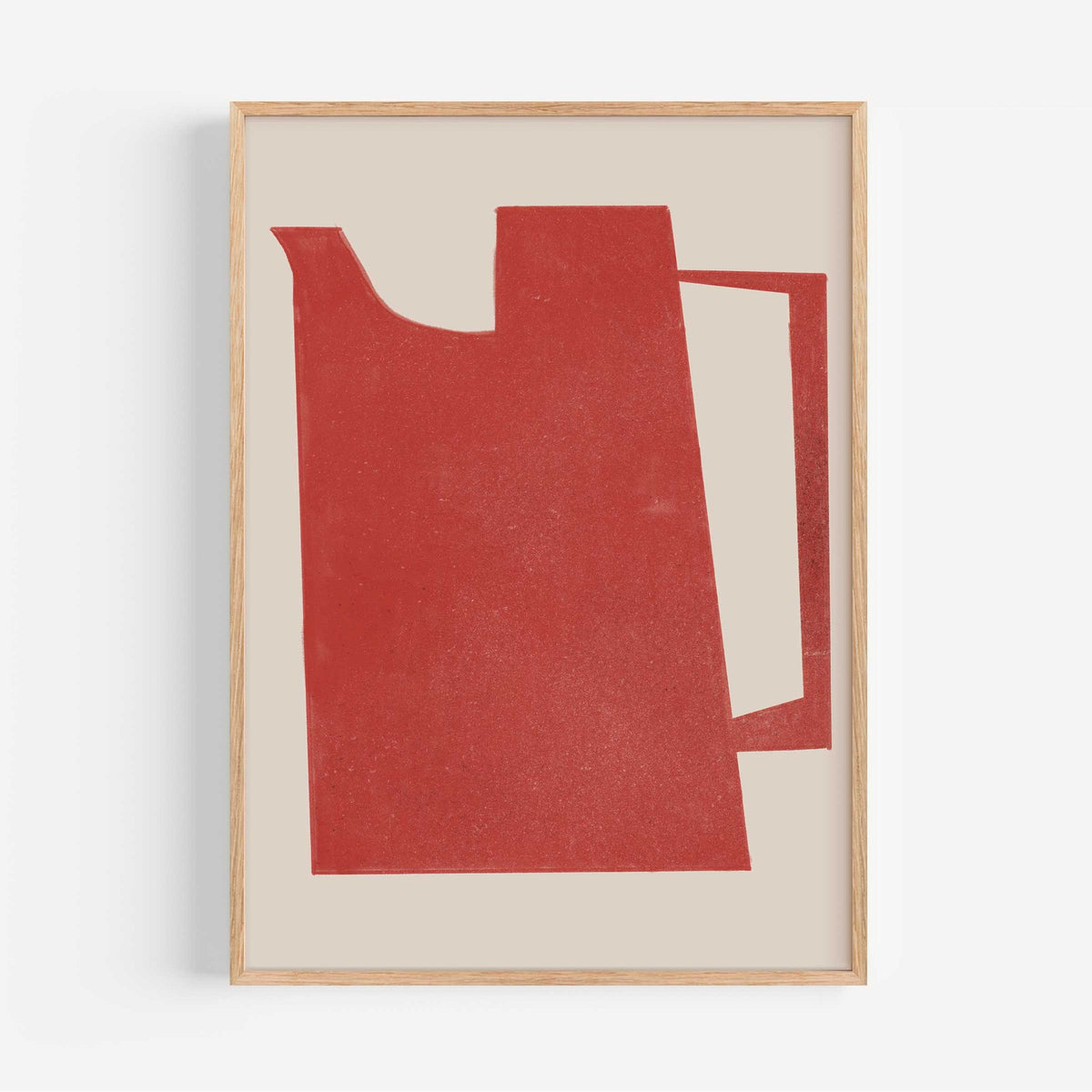 A framed minimalist art print featuring a textured red abstract shape resembling a teapot or pitcher on a warm beige background, enclosed in a light natural wood frame.